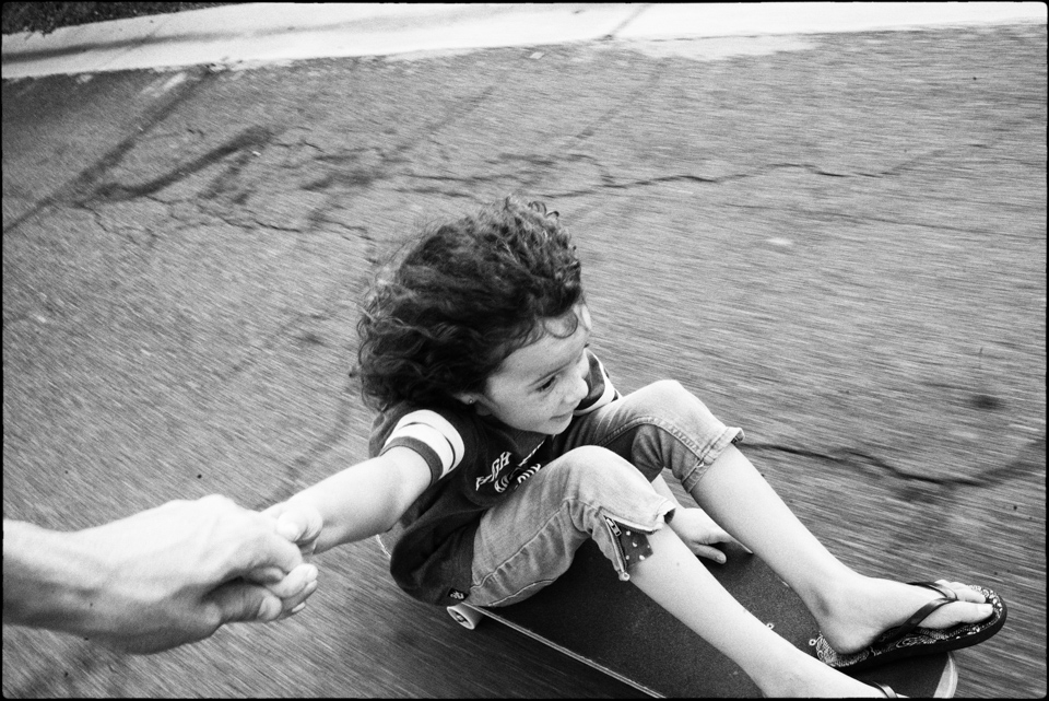 Kids being pulled along on skateboard